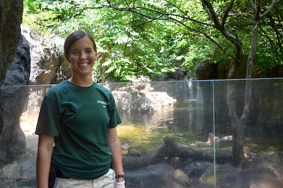 zoo keeper posing near otter exhibit