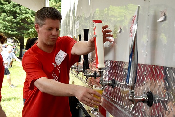 volunteer pouring beer