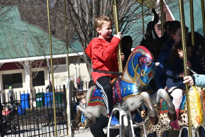 boy riding carousel