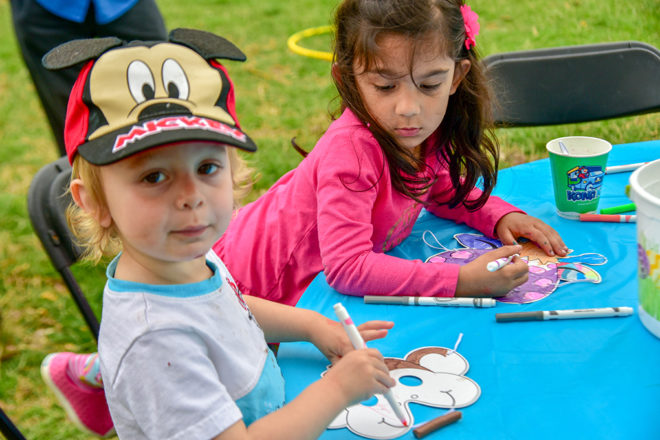 children coloring animal masks.