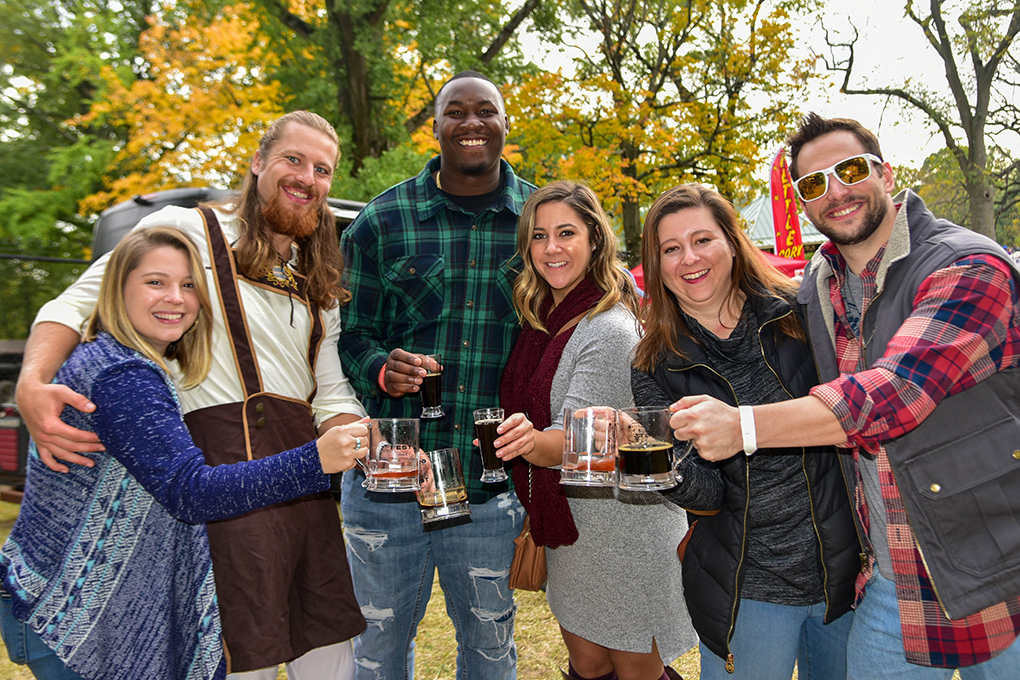 group of people holding beer mugs