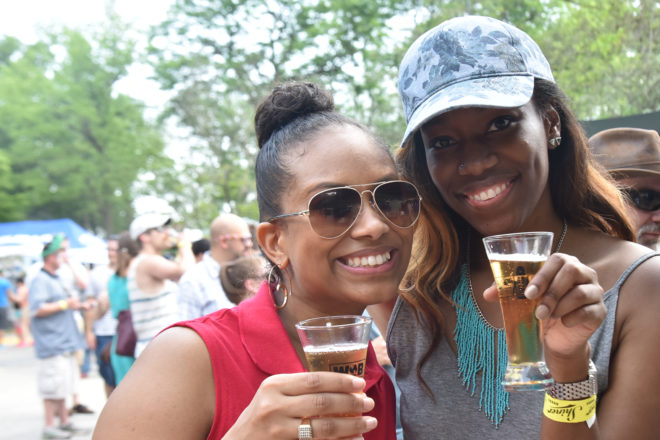 two women with beer glasses at brew at the zoo event.