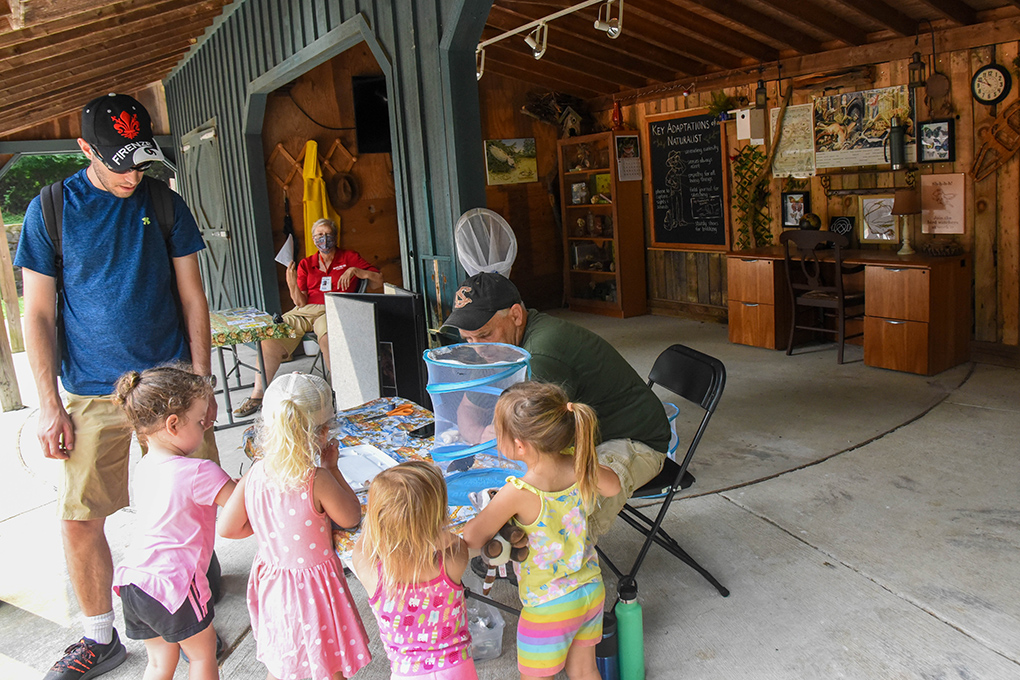 educator teaching children at the naturalist lodge.