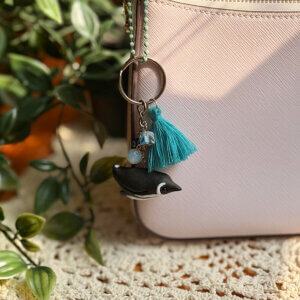Clay penguin charm craft on bag