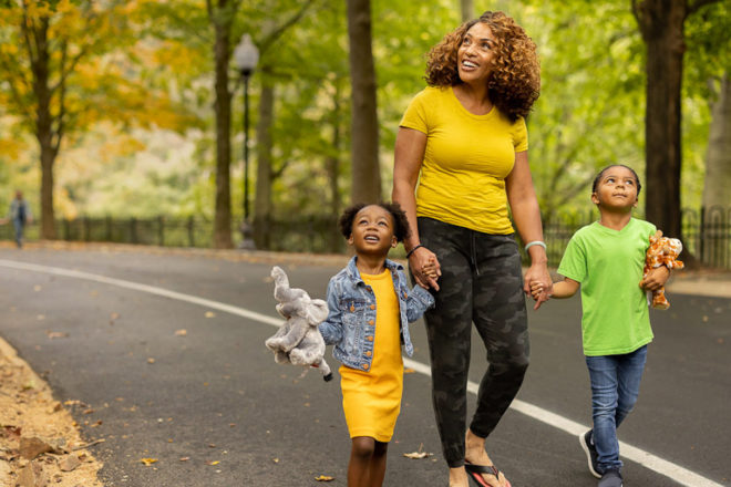 woman walking with two children