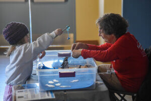 Volunteer doing activity with child guest
