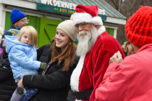 Santa taking a photo with guests