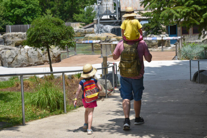 father with two children in safari hats