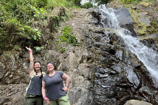 zoo staff in front of waterfall