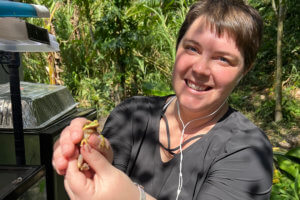 zoo staff member holding frog