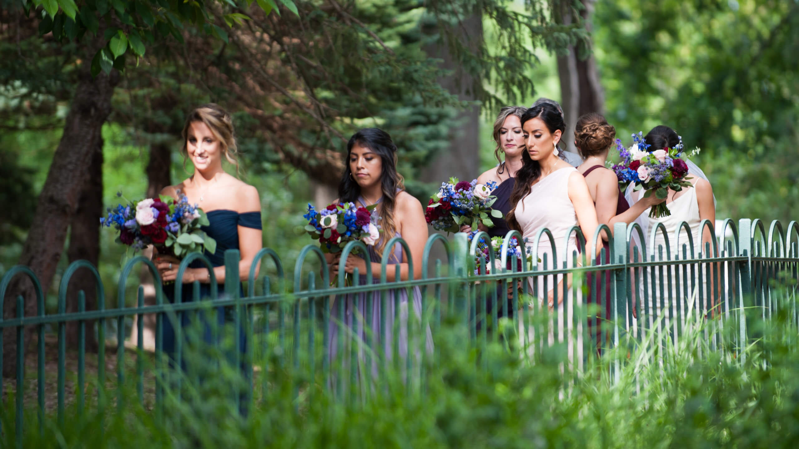 wedding procession walking down lush pathway