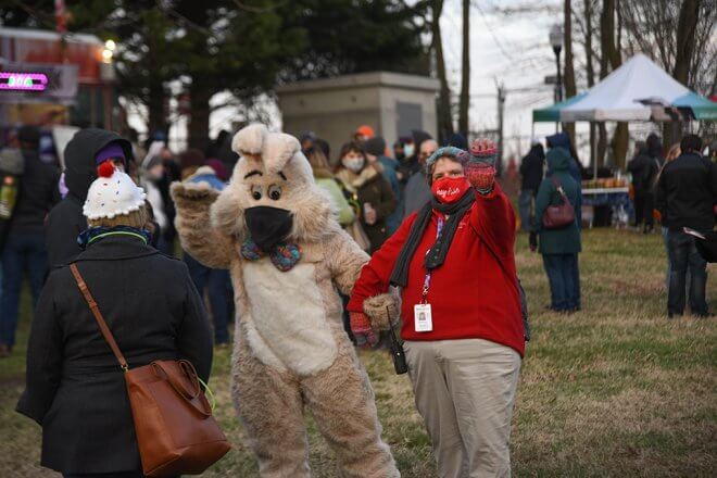 volunteer walking with easter bunny mascot