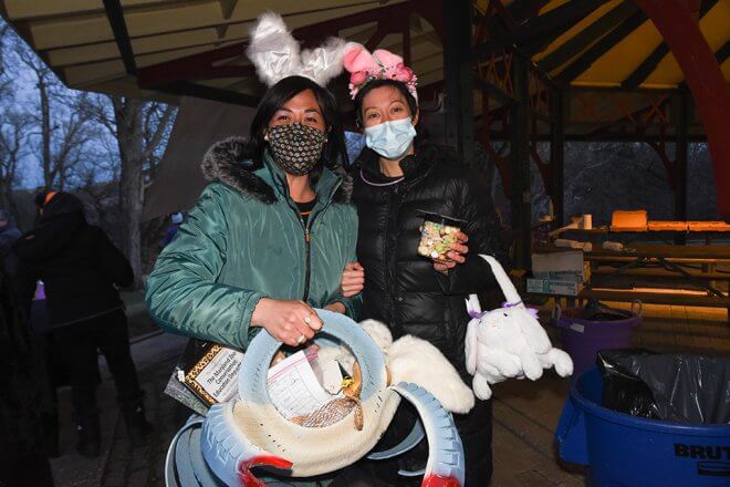 women in bunny ears holding prizes