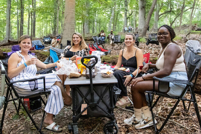 Group of guests sitting together at Wine in the Wilderness