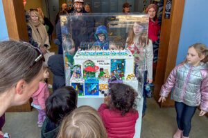 Guests looking at the lego birthday cake